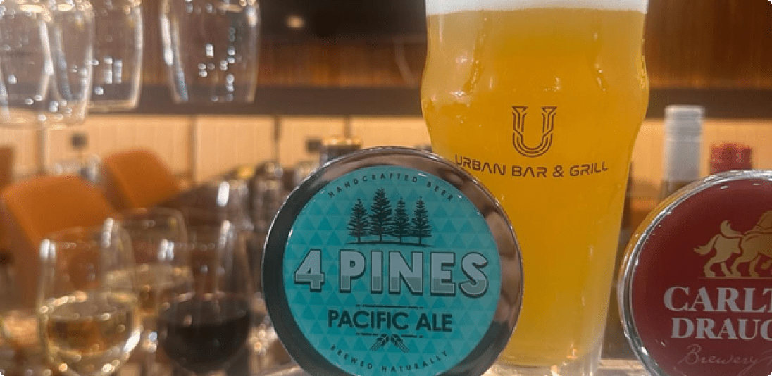 A new beer tap showcased against a backdrop of filled beer glasses, capturing the unique bar experience of Canberra