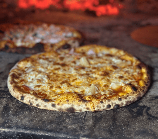 Delicious pizza Cooked in Wood Fire Oven