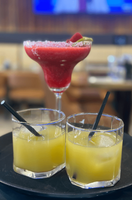 indulge in the refreshing allure of virgin strawberry margaritas. Sugar-kissed rims adorn tall glasses, brimming with vibrant fruit cocktails, promising a delightful escape.
